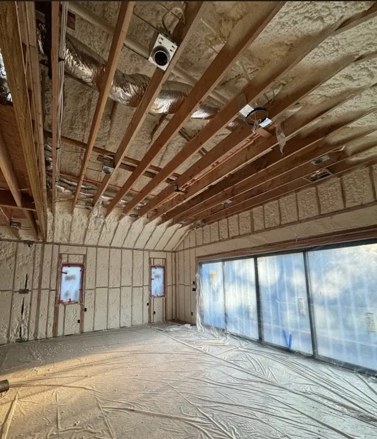 Interior walls and ceiling insulated with spray foam during new construction in North East